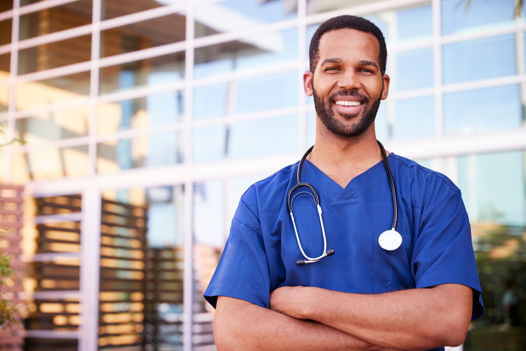Young Black Male Healthcare Worker Smiling outside, Portrait